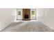 Living room featuring brick fireplace, white door, and carpet floors at 1617 Mulberry Cir, Rock Hill, SC 29732