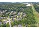 An aerial view reveals a neighborhood nestled among lush greenery, showcasing the homes and surrounding landscape at 184 Melbourne Dr, Fort Mill, SC 29708