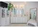 Bright bathroom boasts double vanity with gold fixtures, framed mirrors, TV, and plenty of storage at 184 Melbourne Dr, Fort Mill, SC 29708
