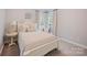 A well-lit bedroom features carpet and a cozy bed at 184 Melbourne Dr, Fort Mill, SC 29708