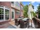 This deck features a cozy outdoor dining area with a table, umbrella, and a view of the lush backyard at 184 Melbourne Dr, Fort Mill, SC 29708