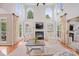 Bright living room with fireplace, built-ins, hardwood floors, and tall windows at 184 Melbourne Dr, Fort Mill, SC 29708