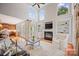 Open-concept living room with hardwood floors, fireplace, built-in shelves, and a glimpse of the kitchen at 184 Melbourne Dr, Fort Mill, SC 29708