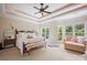 A bright primary suite with a large bed, sitting area, and many windows at 184 Melbourne Dr, Fort Mill, SC 29708