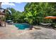 A beautiful pool with hammocks and an umbrella, surrounded by lush greenery, offers the perfect outdoor retreat at 184 Melbourne Dr, Fort Mill, SC 29708