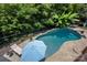 This backyard has a refreshing in-ground pool with a sun lounger, perfect for relaxing and enjoying the outdoors at 184 Melbourne Dr, Fort Mill, SC 29708
