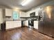 Well-lit kitchen with stainless steel appliances, white cabinets, and granite countertops at 1916 Country Way, Hickory, NC 28601