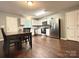 Open kitchen and dining area featuring stainless steel appliances and white cabinets at 1916 Country Way, Hickory, NC 28601