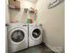 Well-lit laundry room featuring a washer and dryer with shelving at 1916 Country Way, Hickory, NC 28601