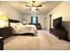 A spacious main bedroom with a ceiling fan, window with curtains, and an adjacent sitting area at 1916 Country Way, Hickory, NC 28601