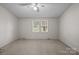 Bedroom featuring light neutral walls, carpet, and a window providing natural light at 200 Southwood Park Rd, Mooresville, NC 28117