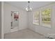 Simple dining room with two windows and a doorway to the kitchen and laundry area at 200 Southwood Park Rd, Mooresville, NC 28117