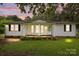 Charming one-story home featuring a covered porch and well-maintained front yard with mature landscaping at 200 Southwood Park Rd, Mooresville, NC 28117