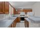 Efficient kitchen layout with wooden cabinets, an island, and ample counter space at 200 Southwood Park Rd, Mooresville, NC 28117