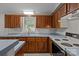 Well-lit kitchen with wooden cabinets, laminate countertops, and essential appliances at 200 Southwood Park Rd, Mooresville, NC 28117
