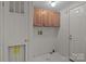 Utility room with wood cabinets, utility door, and laundry space at 200 Southwood Park Rd, Mooresville, NC 28117