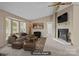 Cozy living room with a fireplace, large bay windows, and stylish furnishings at 200 Southwood Park Rd, Mooresville, NC 28117