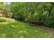 Lush backyard featuring mature trees, offering shade and a natural setting at 2005 Scott Ave, Charlotte, NC 28203