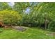 Beautiful backyard with mature trees and a garden, creating a private and tranquil outdoor space at 2005 Scott Ave, Charlotte, NC 28203