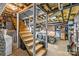 Unfinished basement with exposed ceilings and wooden stairs, and neutral paint at 2005 Scott Ave, Charlotte, NC 28203