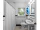 Traditional bathroom with tiled floors and walls, and a shower with a shower curtain at 2005 Scott Ave, Charlotte, NC 28203