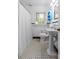 Bathroom featuring tiled floors, a pedestal sink, and a window providing natural light at 2005 Scott Ave, Charlotte, NC 28203