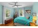 Bright bedroom with a ceiling fan, wood floors, and stylish furnishings at 2005 Scott Ave, Charlotte, NC 28203