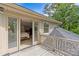 Home's deck with view into primary bedroom, and backyard with mature trees at 2005 Scott Ave, Charlotte, NC 28203