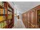 Hallway with lots of storage, with built-in bookshelves and cupboards, and neutral carpet at 2005 Scott Ave, Charlotte, NC 28203