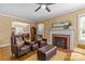 Inviting living room features cozy seating, fireplace, and access to dining area at 2005 Scott Ave, Charlotte, NC 28203