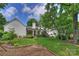 Expansive backyard featuring an outdoor dining area, well-maintained lawn, and mature trees at 2011 Fromby Ct, Charlotte, NC 28211