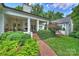Charming brick home with a covered porch and manicured landscaping creating a welcoming outdoor space at 2011 Fromby Ct, Charlotte, NC 28211