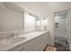 A bright bathroom featuring double sinks and a bathtub with white subway tile at 2011 Fromby Ct, Charlotte, NC 28211