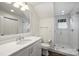 Bright bathroom with white vanity, marble countertop and sleek glass enclosed shower at 2011 Fromby Ct, Charlotte, NC 28211