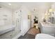 Bright bathroom featuring a tiled shower with bench seat, modern fixtures, and double vanity at 2011 Fromby Ct, Charlotte, NC 28211