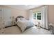 Cozy bedroom with a floral patterned bed, plush rug, and large window with natural light at 2011 Fromby Ct, Charlotte, NC 28211