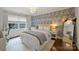 Cozy bedroom with patterned wallpaper, white bed frame, and a window for ample natural light at 2011 Fromby Ct, Charlotte, NC 28211