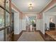Inviting foyer with hardwood floors, detailed trim, and a view to other rooms at 2011 Fromby Ct, Charlotte, NC 28211
