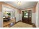 Inviting foyer with detailed trim, hardwood floors and view to the formal dining at 2011 Fromby Ct, Charlotte, NC 28211