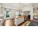 Bright, well-appointed kitchen features an island, modern appliances, and hardwood floors at 2011 Fromby Ct, Charlotte, NC 28211