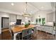 Modern kitchen with custom cabinets, black countertops, and a large center island at 2011 Fromby Ct, Charlotte, NC 28211