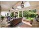 Comfortable outdoor living space with brick floors, wicker furniture and a ceiling fan at 2011 Fromby Ct, Charlotte, NC 28211