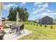 Spacious backyard features a patio set, swing set, and ample greenspace to enjoy the outdoors at 205 Falls Cove Dr, Troutman, NC 28166
