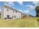 Expansive backyard with patio, seating, and playset at 205 Falls Cove Dr, Troutman, NC 28166