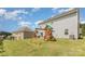 Large backyard with wooden playset featuring a swing and slide at 205 Falls Cove Dr, Troutman, NC 28166
