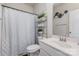 A bathroom with decorative curtain and fixtures, as well as a double sink vanity and storage shelving at 205 Falls Cove Dr, Troutman, NC 28166