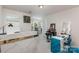 This bedroom is set up as a home business space with a salon table, bright lighting, and plenty of work area at 205 Falls Cove Dr, Troutman, NC 28166