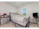 Bedroom featuring a tufted headboard, plush rug, and ample natural light at 205 Falls Cove Dr, Troutman, NC 28166