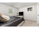 Neutral bedroom with dark furnishings, plush pillows, and a large window view at 205 Falls Cove Dr, Troutman, NC 28166