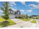 Charming two-story home with a well-manicured lawn and inviting front porch at 205 Falls Cove Dr, Troutman, NC 28166